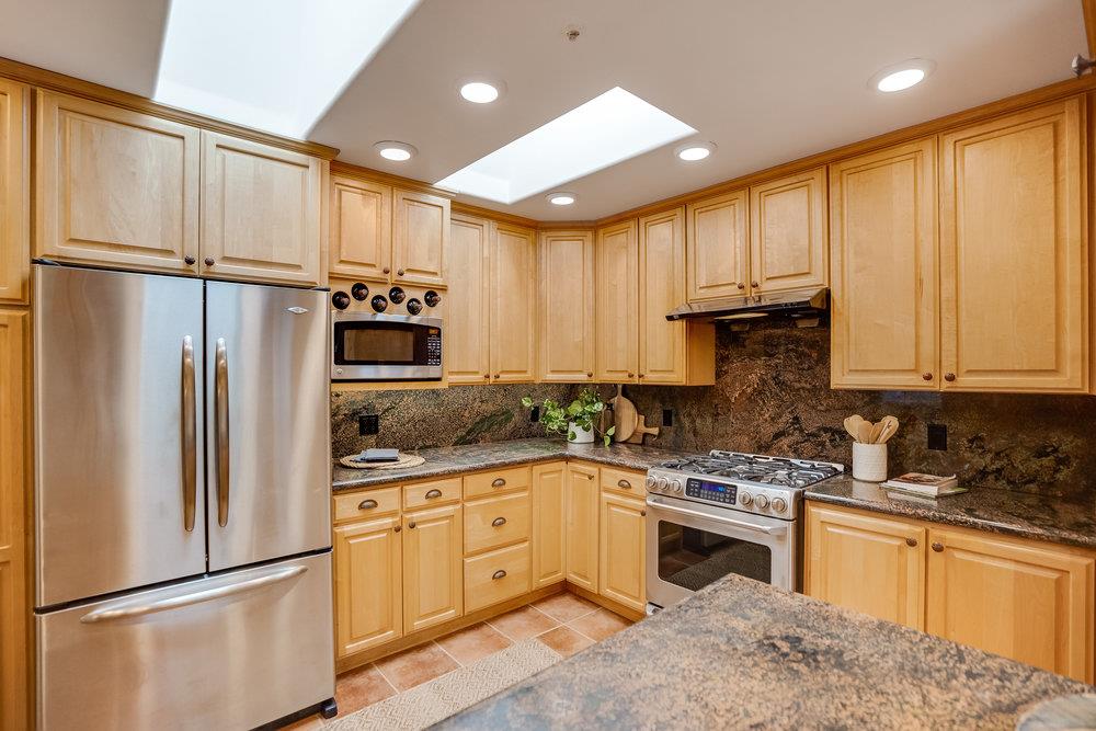 1067 Rio Vista Drive Pacifica, CA 94044 - Photo 8 of 43 a kitchen with stainless steel appliances granite countertop a refrigerator sink and cabinets