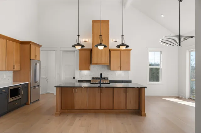 a kitchen with refrigerator and cabinets