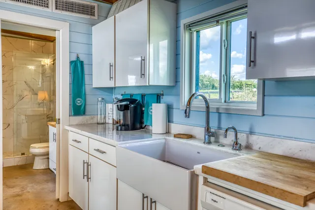 a bathroom with a granite countertop sink toilet a mirror and shower