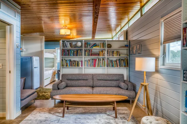 a view of a porch with wooden floor and a yard