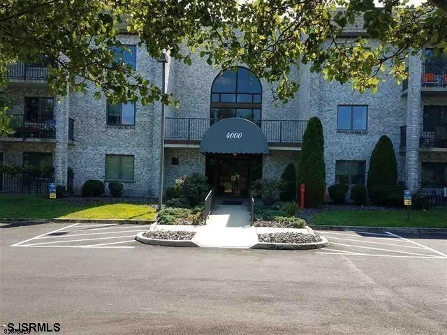 a view of a house with a yard and tree s
