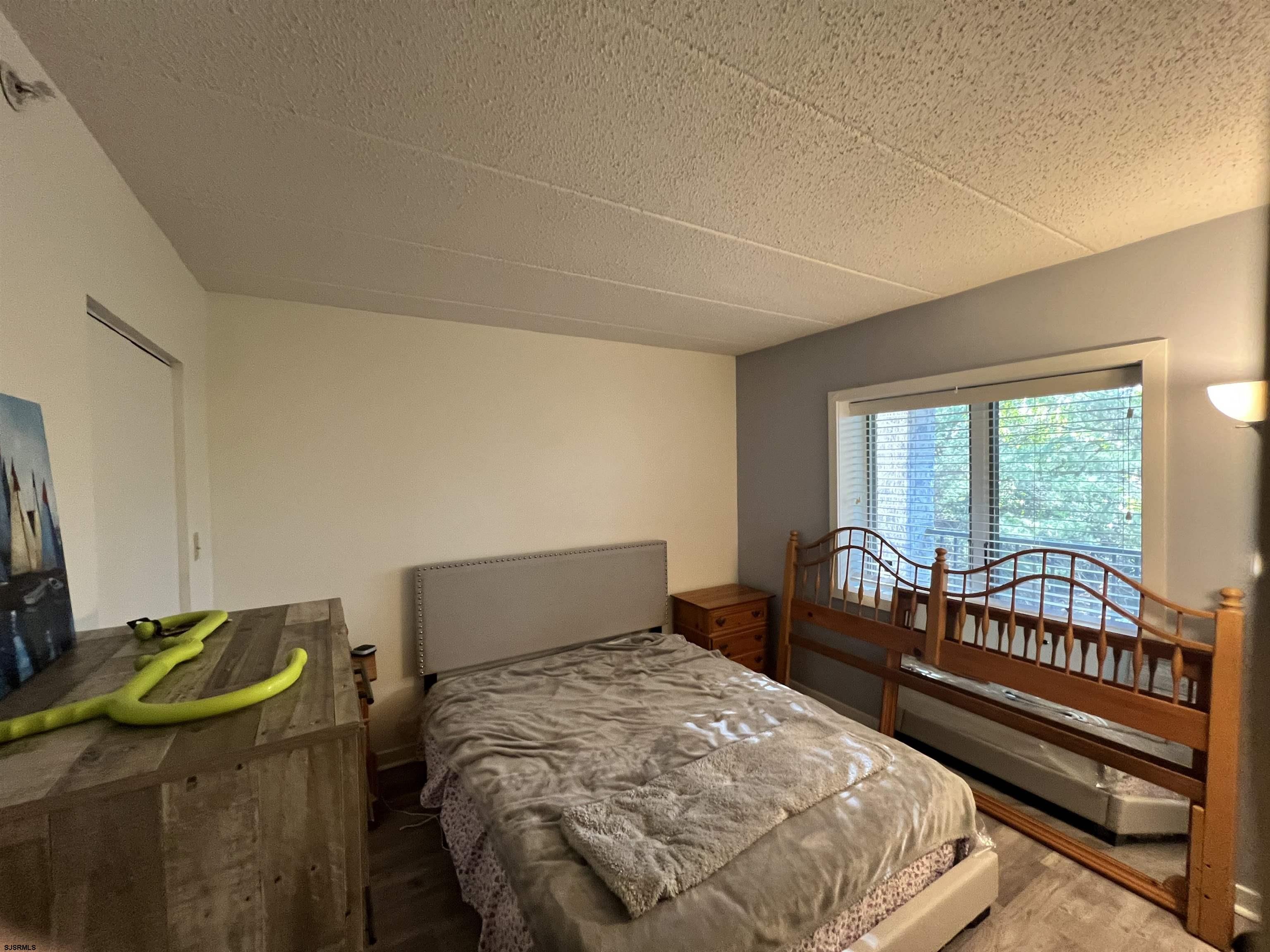 4310 Dolphin Avenue, Unit 4310 Northfield, NJ 08225 - Photo 11 of 21 a bedroom with a bed and a window