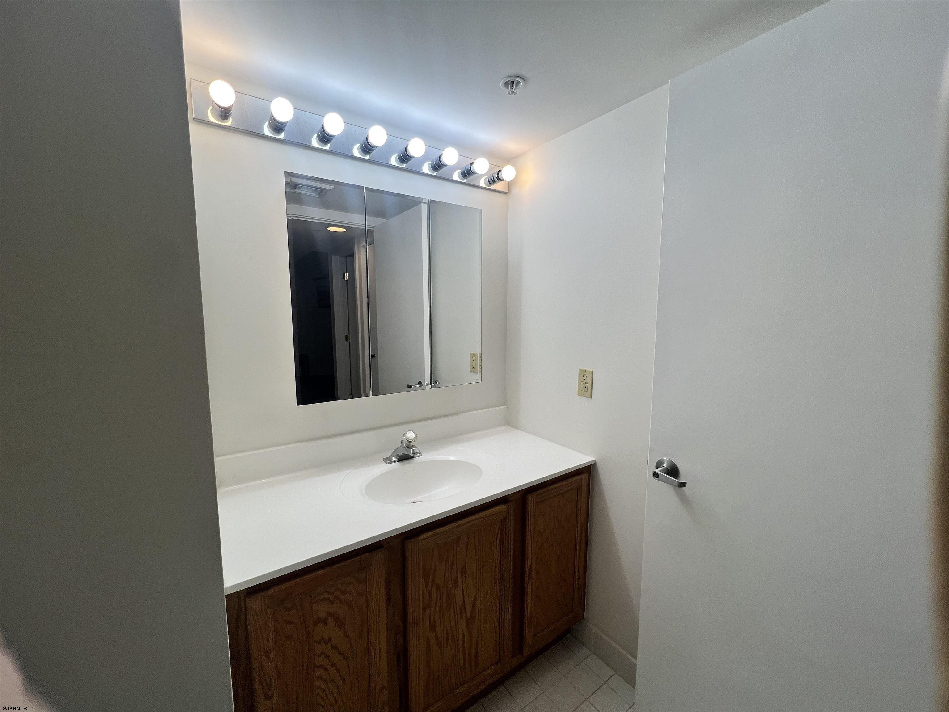4310 Dolphin Avenue, Unit 4310 Northfield, NJ 08225 - Photo 14 of 21 a bathroom with a sink and a mirror