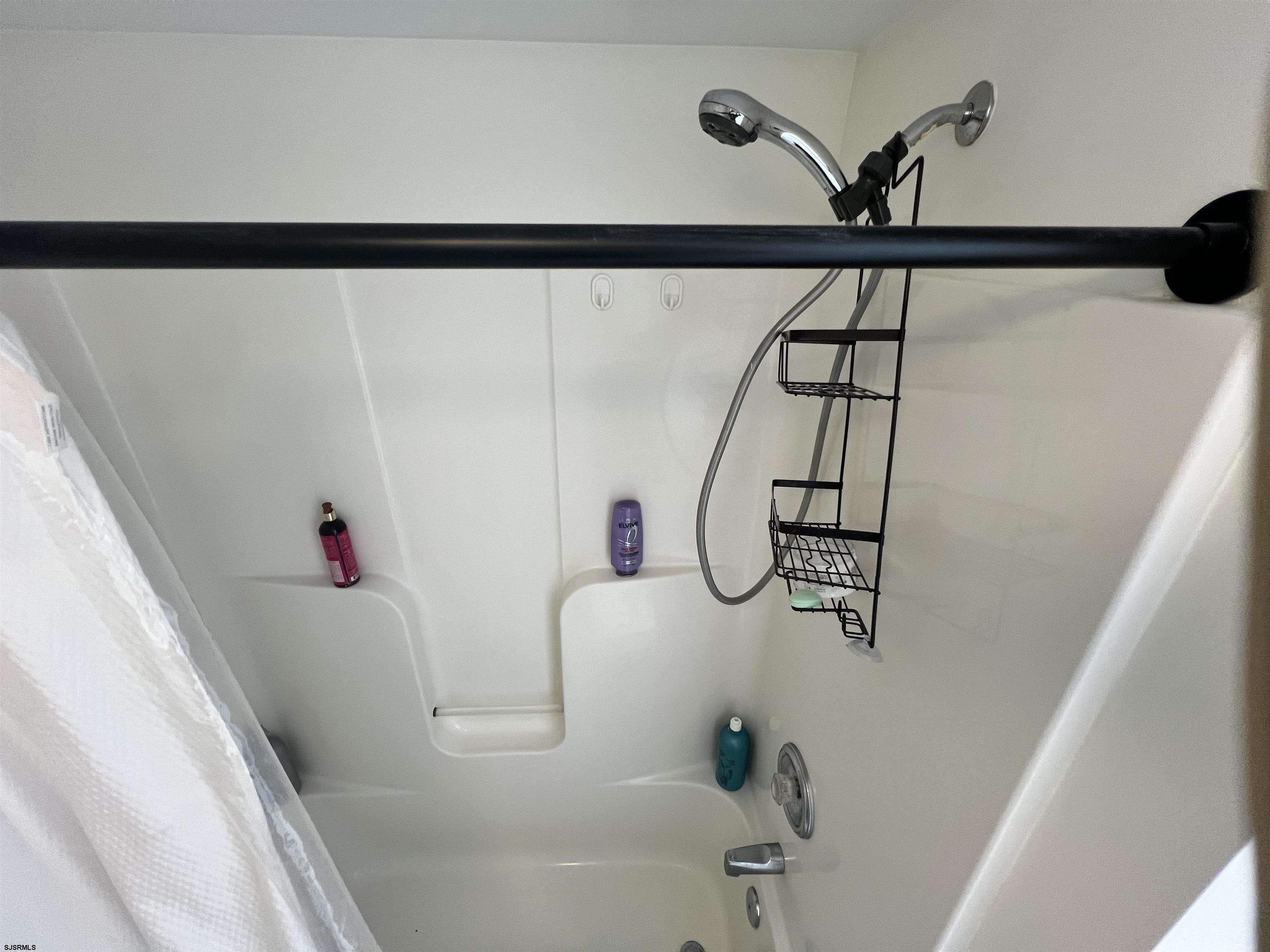 4310 Dolphin Avenue, Unit 4310 Northfield, NJ 08225 - Photo 15 of 21 a bathroom with a bathtub and shower