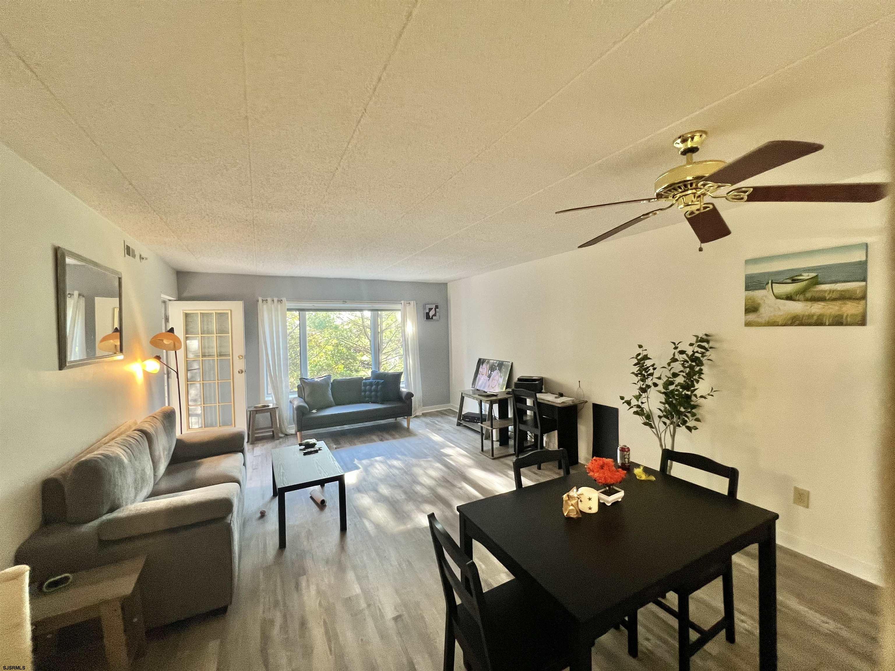 4310 Dolphin Avenue, Unit 4310 Northfield, NJ 08225 - Photo 7 of 21 a living room with furniture and a window