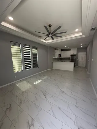 a view of a livingroom with a ceiling fan and window