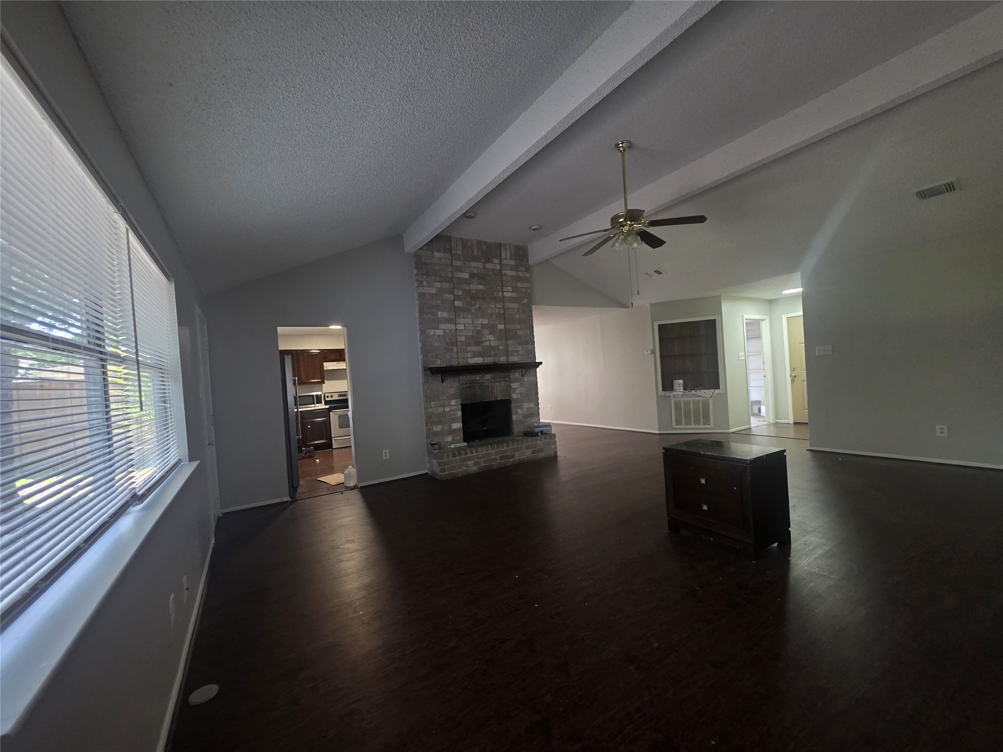 23322 Dew Wood Lane Spring, TX 77373 - Photo 5 of 20 an empty room with wooden floor fireplace and windows