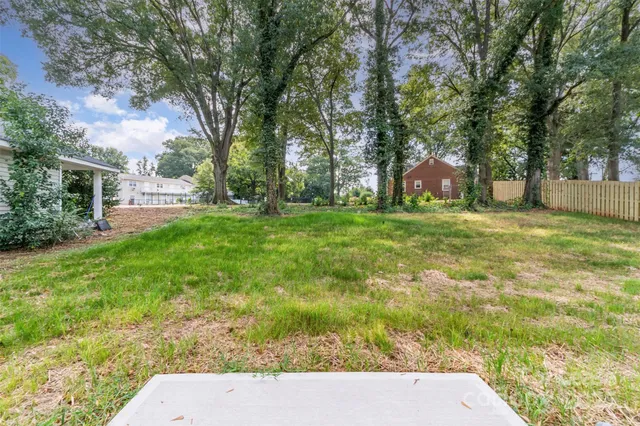a view of a backyard with large trees