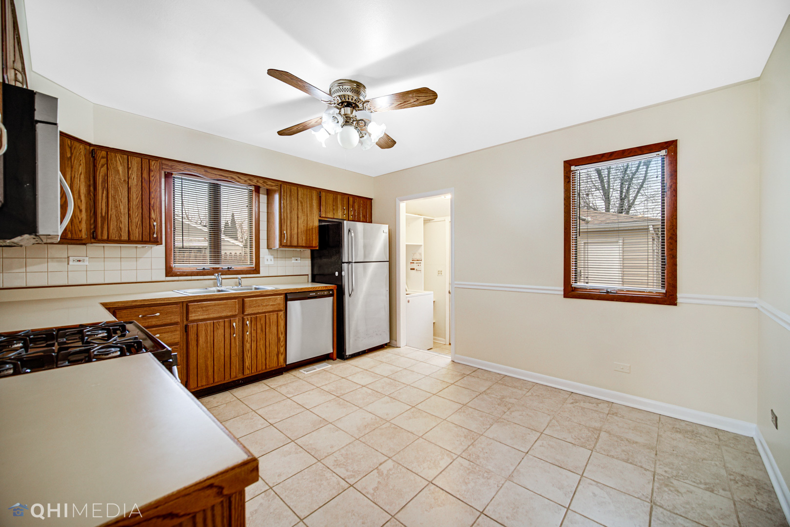 2402 Wing Street Rolling Meadows, IL 60008 - Photo 8 of 20 a kitchen with stainless steel appliances granite countertop a stove a sink dishwasher and a refrigerator