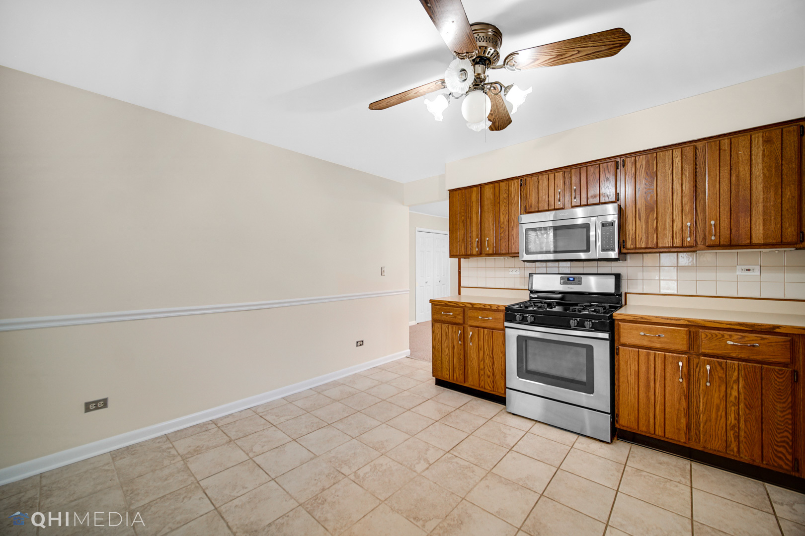 2402 Wing Street Rolling Meadows, IL 60008 - Photo 9 of 20 a kitchen with stainless steel appliances granite countertop a sink a stove top oven and cabinets