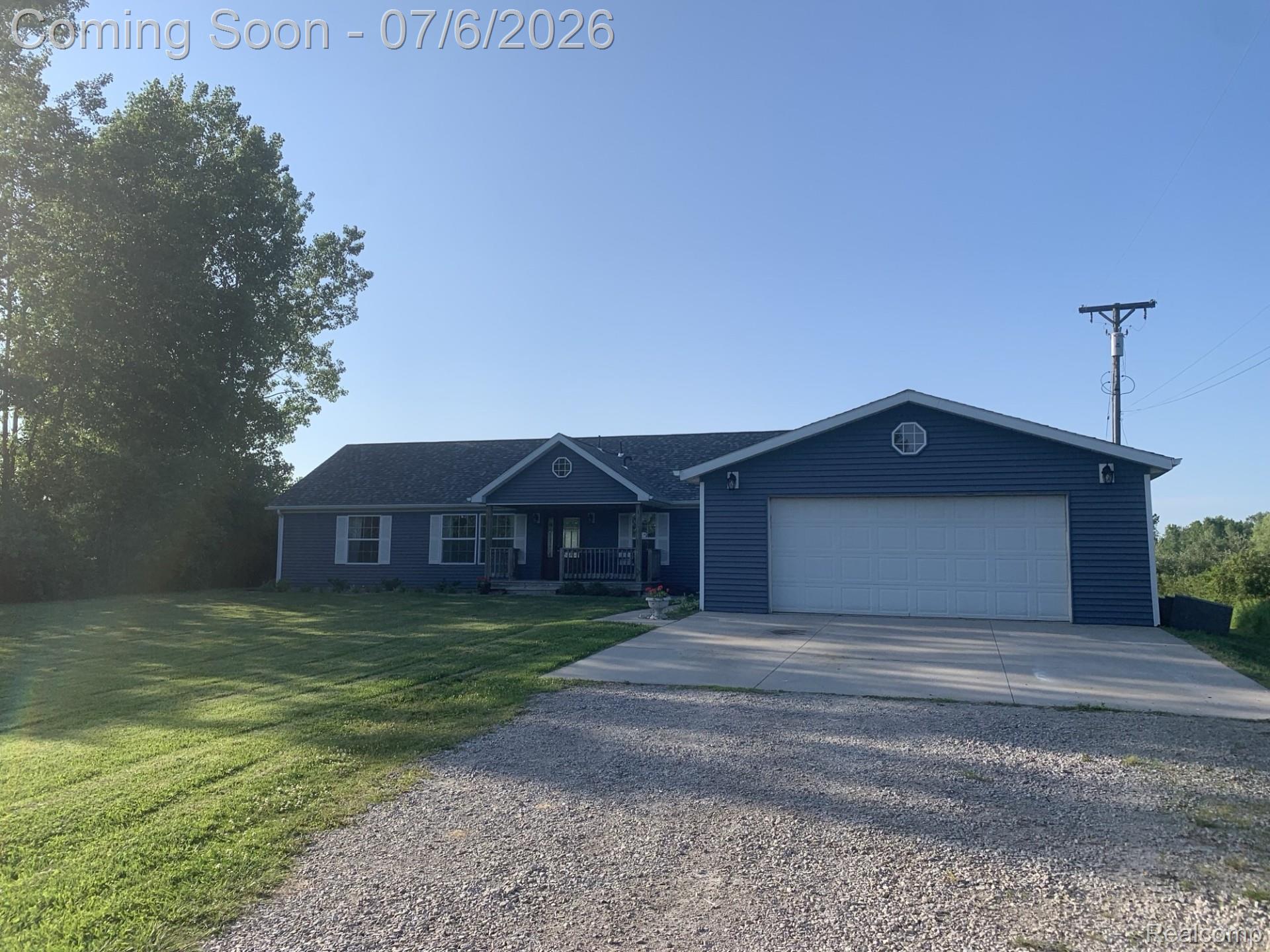 4168 Harris Road Fort Gratiot, MI 48059 - Photo 1 of 30 Ranch-style exterior featuring blue siding, white trim, and a covered front porch