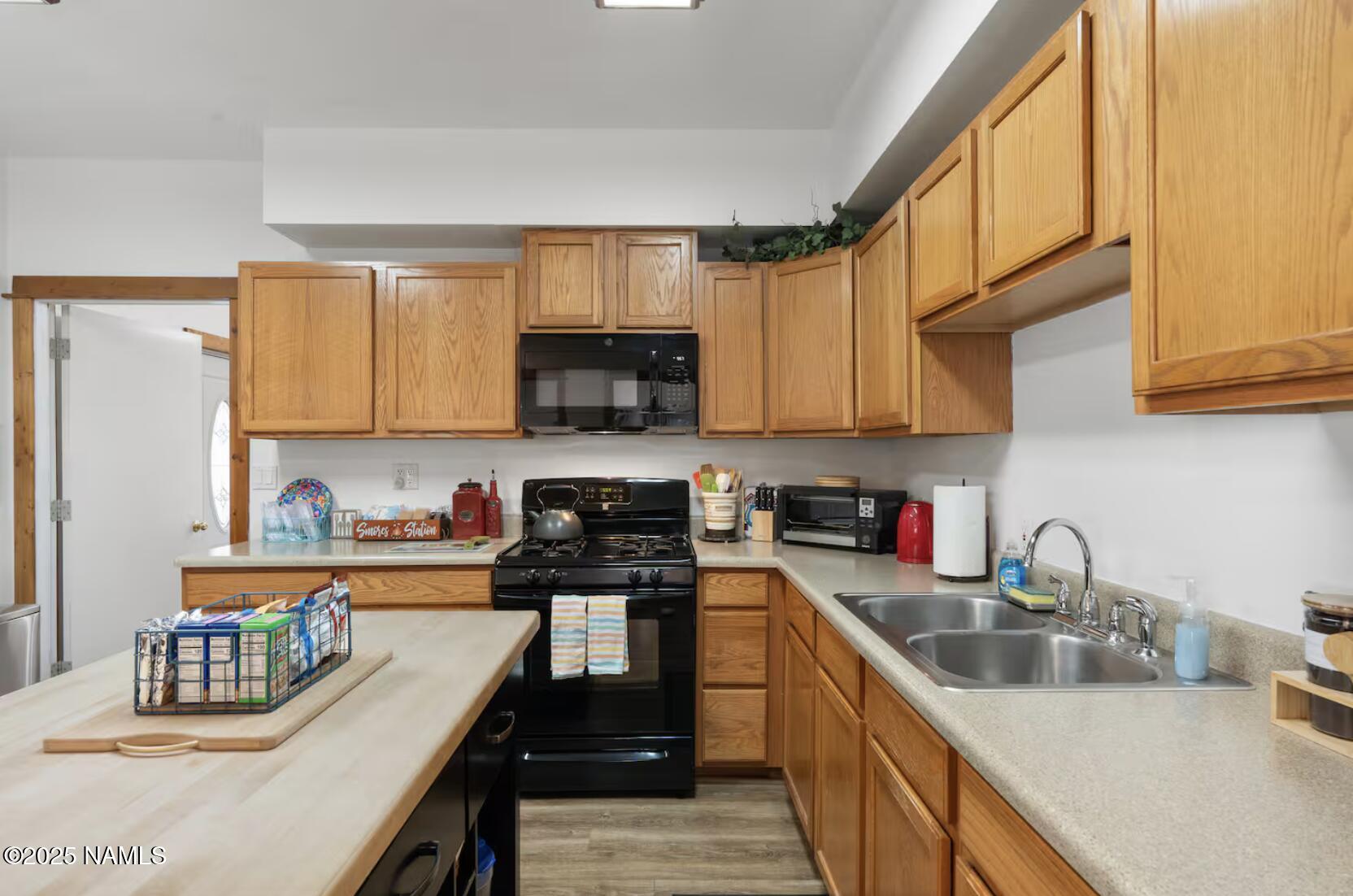 304 South 4th Street Williams, AZ 86046 - Photo 13 of 39 a kitchen with stainless steel appliances granite countertop a sink a stove and a microwave