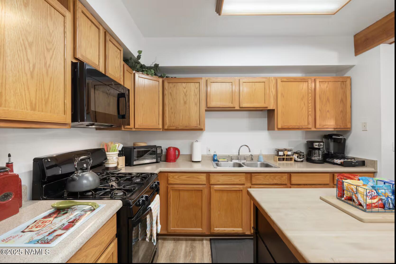 304 South 4th Street Williams, AZ 86046 - Photo 15 of 39 a kitchen with stainless steel appliances granite countertop a sink stove refrigerator and cabinets