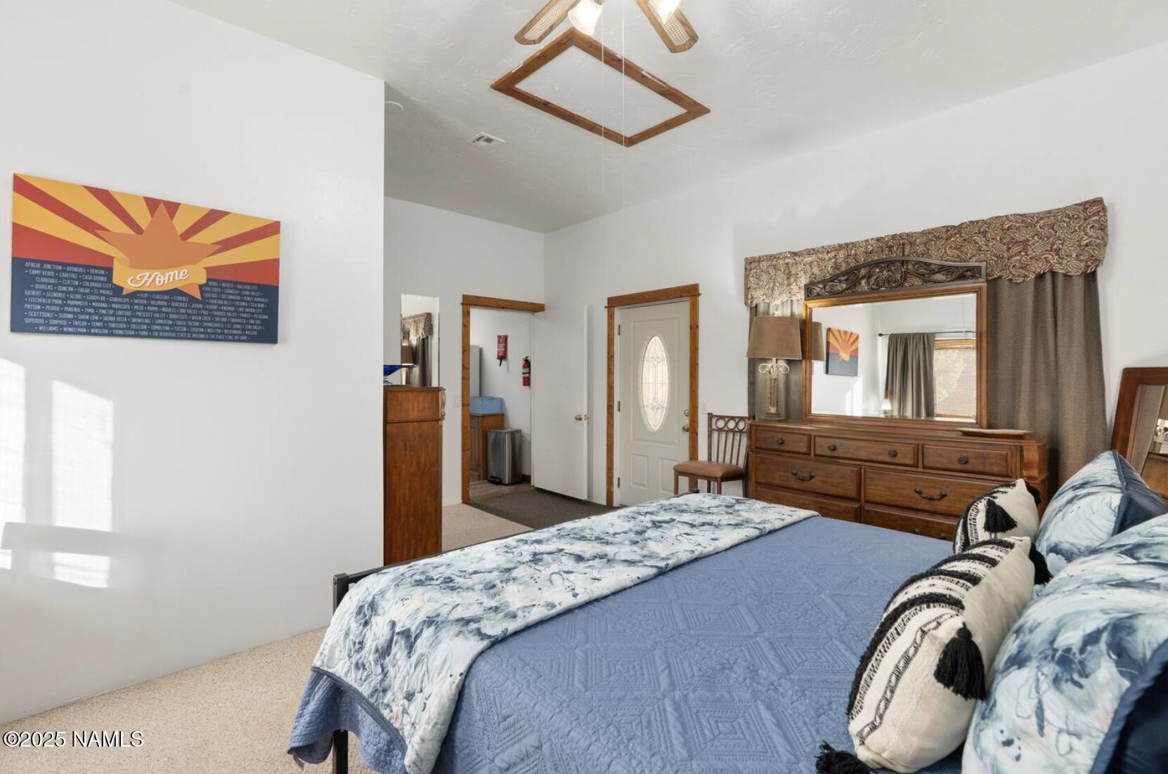 304 South 4th Street Williams, AZ 86046 - Photo 20 of 39 a bedroom with a bed and a chandelier