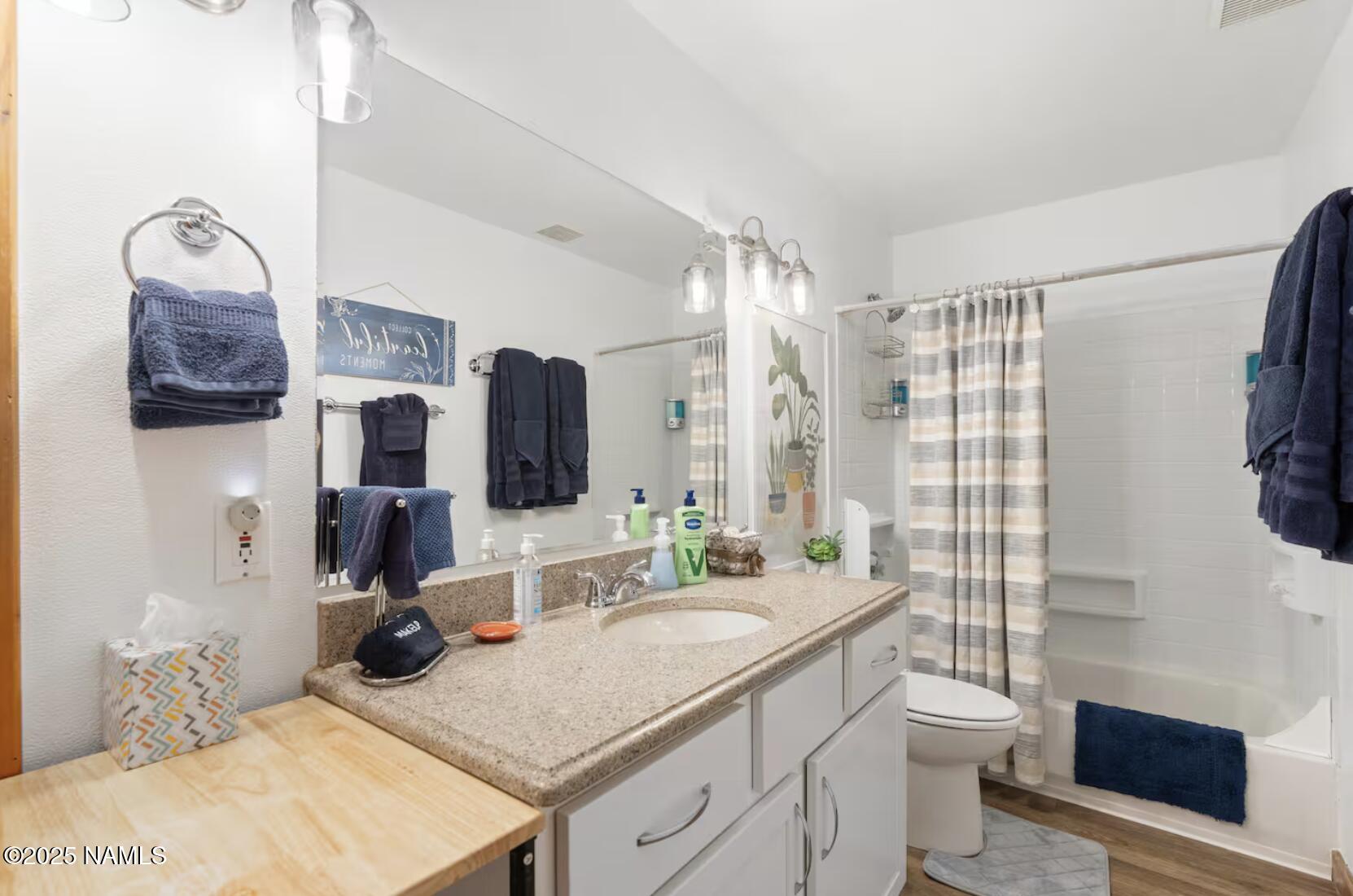 304 South 4th Street Williams, AZ 86046 - Photo 22 of 39 a bathroom with a granite countertop sink a toilet a mirror and shower