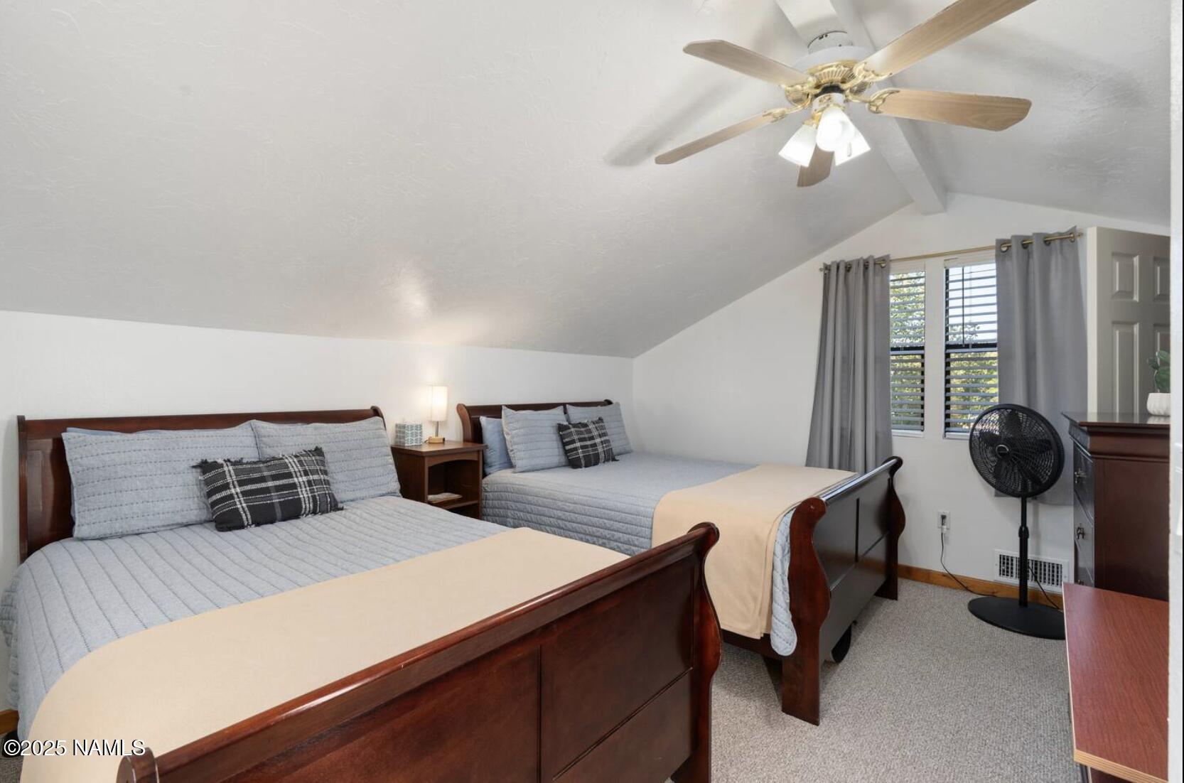 304 South 4th Street Williams, AZ 86046 - Photo 28 of 39 a bedroom with a bed and a chandelier
