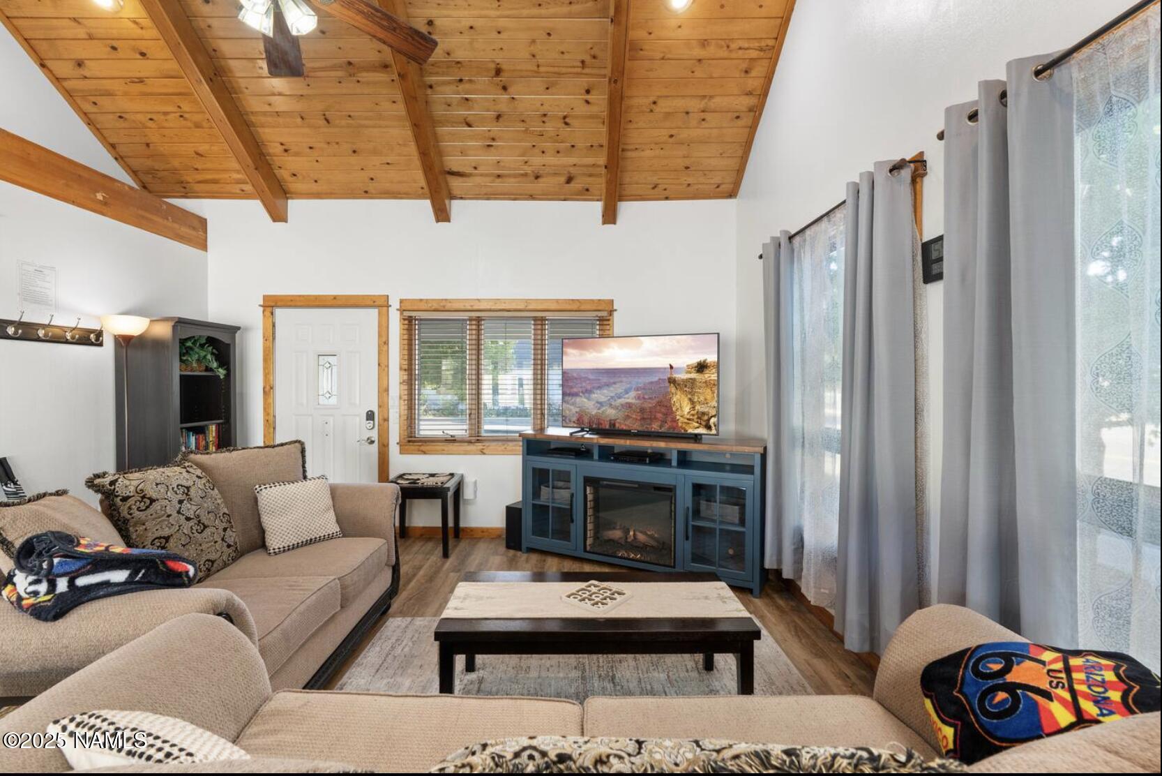 304 South 4th Street Williams, AZ 86046 - Photo 10 of 39 a living room with furniture a flat screen tv and a fireplace