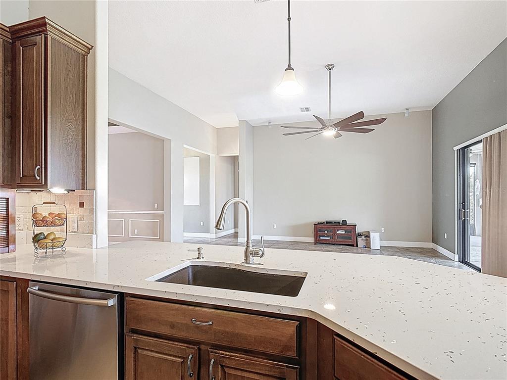 772 San Raphael Street Kissimmee, FL 34759 - Photo 26 of 94 a kitchen with a sink and a refrigerator