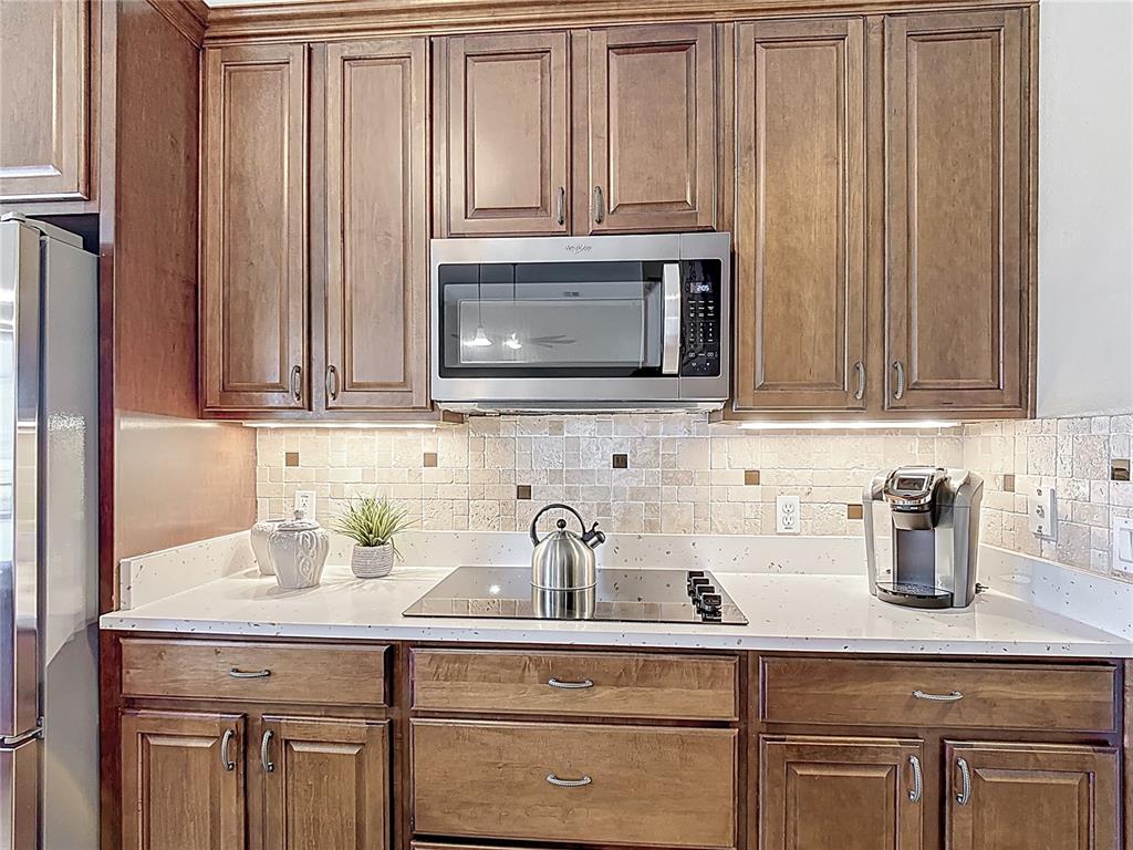 772 San Raphael Street Kissimmee, FL 34759 - Photo 28 of 94 a kitchen with stainless steel appliances granite countertop white cabinets a microwave oven and a sink