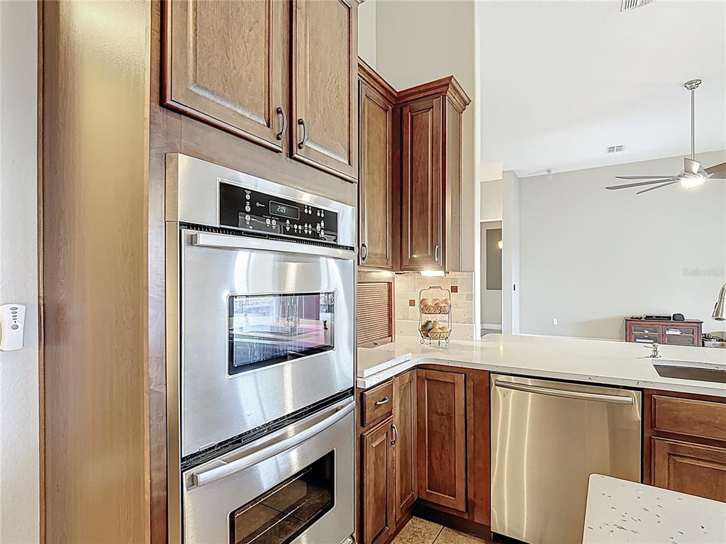772 San Raphael Street Kissimmee, FL 34759 - Photo 29 of 94 a kitchen with stainless steel appliances a stove and a microwave