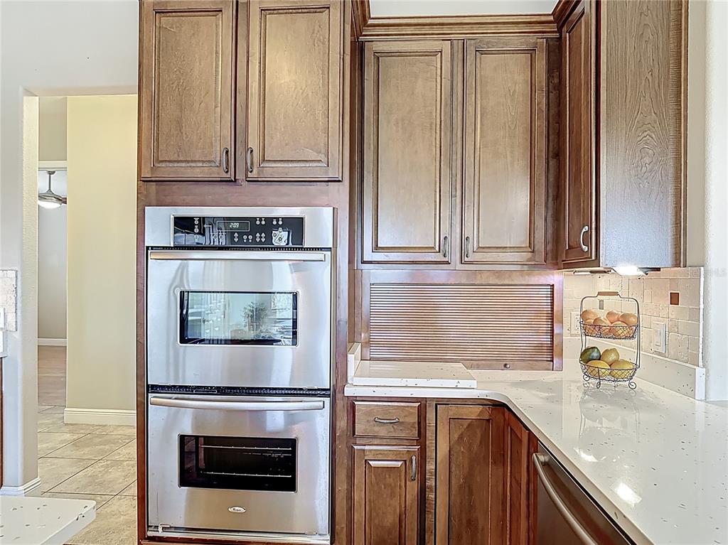 772 San Raphael Street Kissimmee, FL 34759 - Photo 30 of 94 a kitchen with granite countertop white cabinets and stainless steel appliances