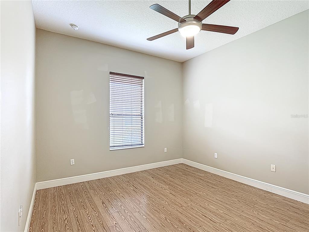 772 San Raphael Street Kissimmee, FL 34759 - Photo 31 of 94 an empty room with a window and a ceiling fan