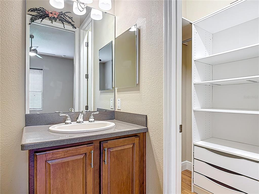 772 San Raphael Street Kissimmee, FL 34759 - Photo 33 of 94 a bathroom with a sink vanity and a mirror