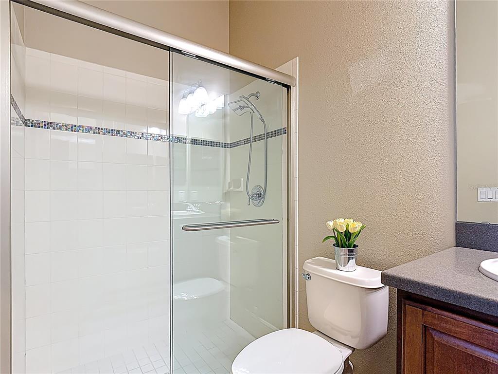 772 San Raphael Street Kissimmee, FL 34759 - Photo 34 of 94 a white toilet sitting next to a bathroom sink