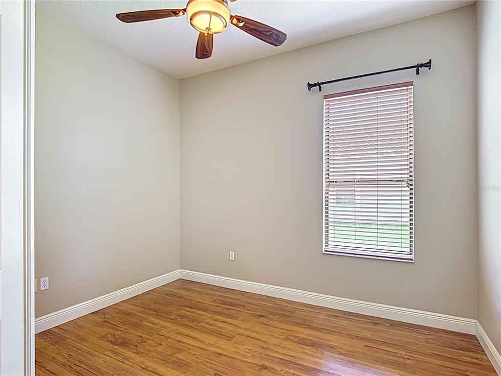 772 San Raphael Street Kissimmee, FL 34759 - Photo 39 of 94 an empty room with wooden floor and windows