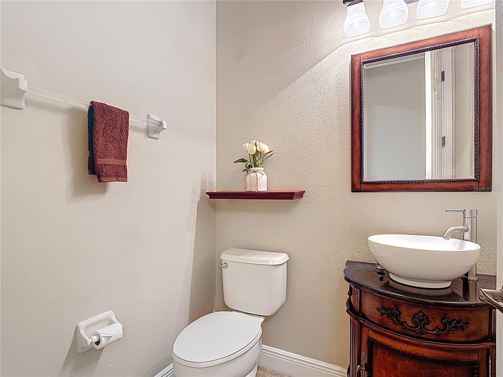772 San Raphael Street Kissimmee, FL 34759 - Photo 41 of 94 a bathroom with a toilet a sink and mirror