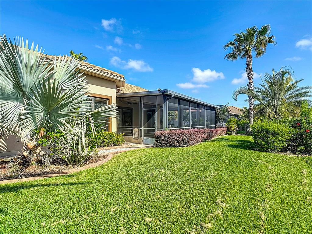 772 San Raphael Street Kissimmee, FL 34759 - Photo 80 of 94 a view of a house with a yard and palm tree