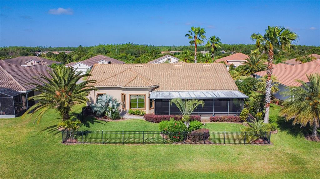 772 San Raphael Street Kissimmee, FL 34759 - Photo 86 of 94 a view of a house with a yard and potted plants