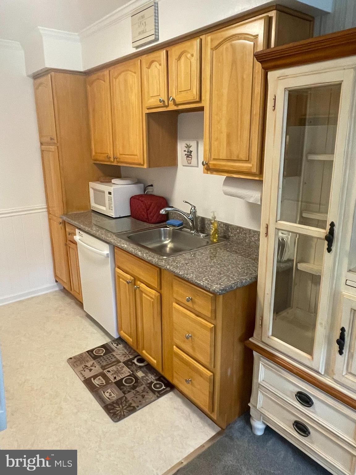 420 North Wayne Avenue, Unit 8 Wayne, PA 19087 - Photo 5 of 18 a kitchen with stainless steel appliances granite countertop a sink stove and cabinets