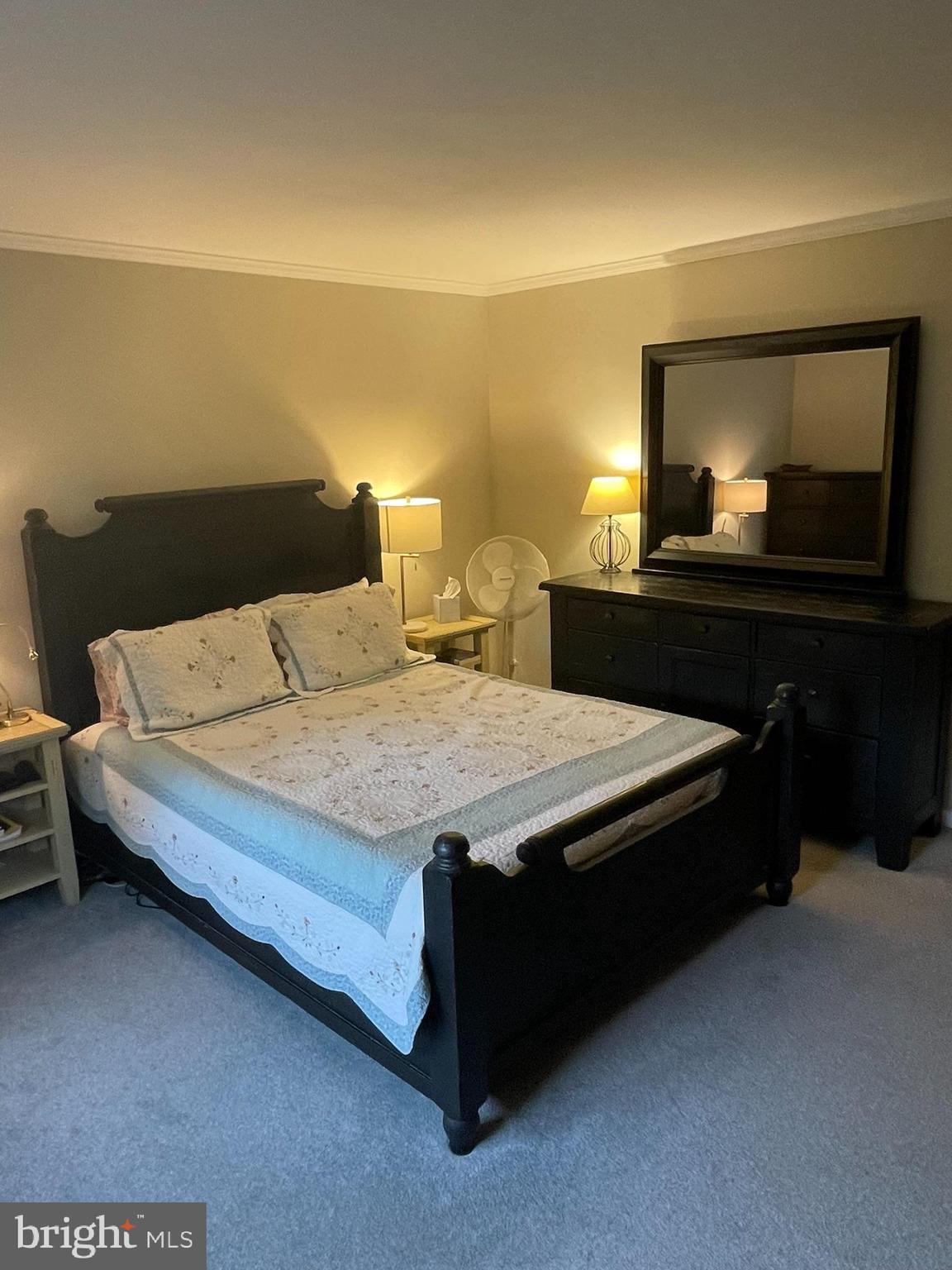 420 North Wayne Avenue, Unit 8 Wayne, PA 19087 - Photo 8 of 18 a bedroom with a bed and a lamp on dresser