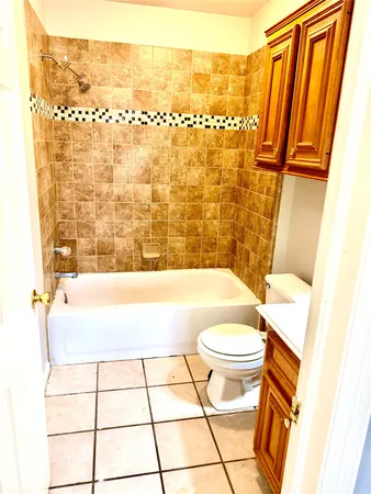 a bathroom with a sink a toilet a mirror and shower