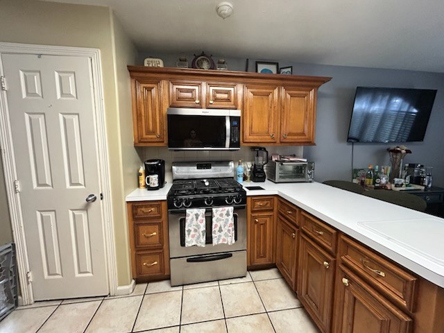 5015 Misty Lane Pasadena, TX 77505 - Photo 3 of 12 a kitchen with stainless steel appliances granite countertop a stove a sink and a microwave