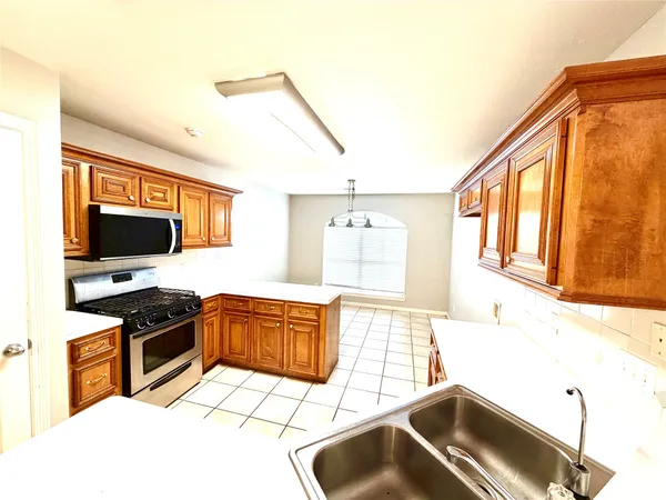 a kitchen with a sink and a stove top oven