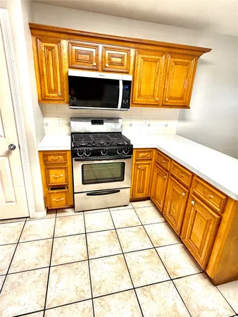 a kitchen with stainless steel appliances a stove a sink and a microwave