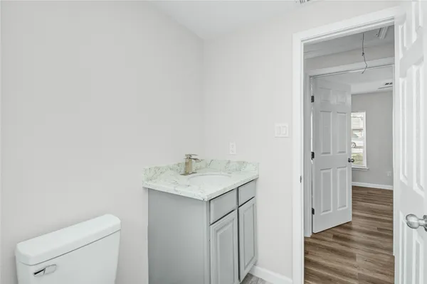 a bathroom with a sink toilet and vanity