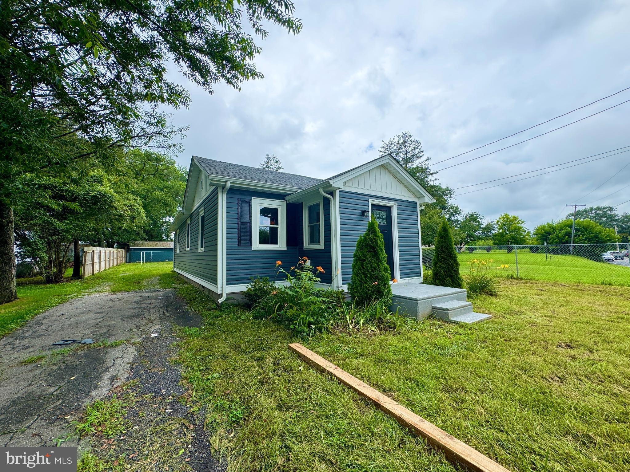 436 Halltown Road Marydel, DE 19964 - Photo 2 of 21 Charming blue cottage with lush greenery.