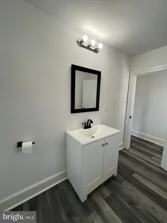 a bathroom with a sink a mirror and vanity