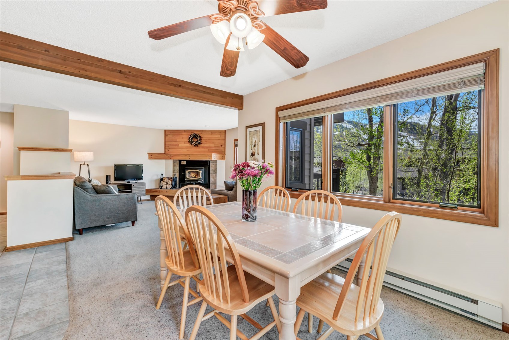 1675 Ranch Road, Unit 411 Steamboat Springs, CO 80487 - Photo 13 of 48 Carpeted dining space featuring beamed ceiling, ceiling fan