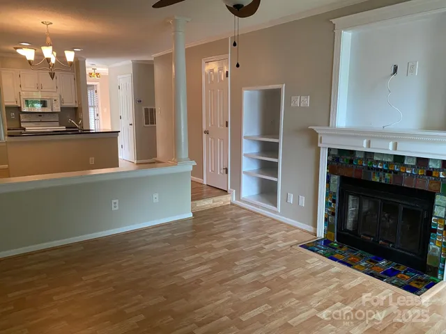 a view of a kitchen with a sink and a fireplace
