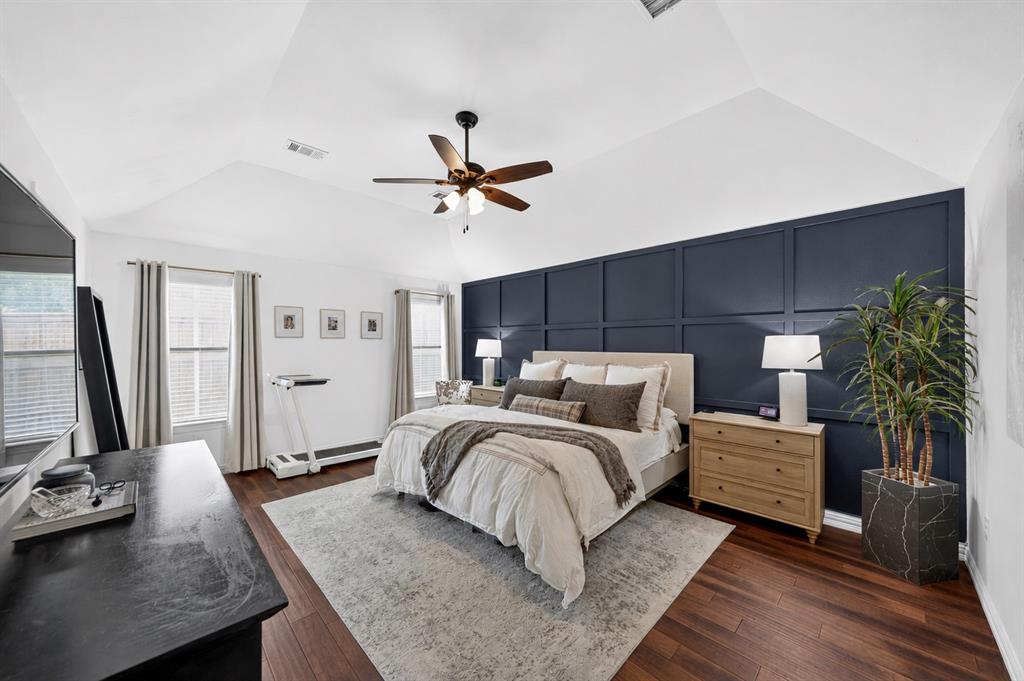 8014 Garner Road Rowlett, TX 75088 - Photo 19 of 39 a large bedroom with a bed and a chandelier