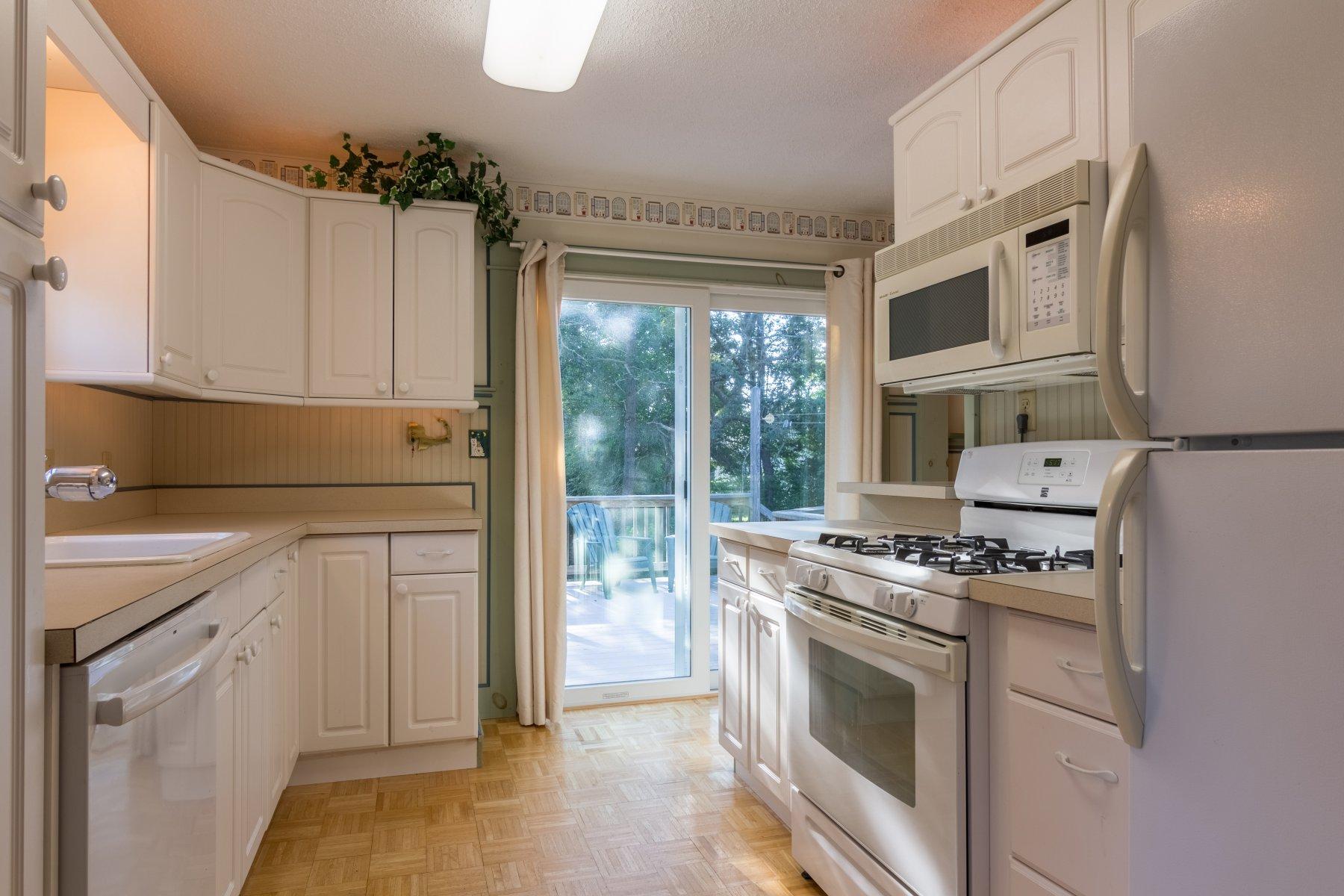 2 Otis Kelly Road Dennis Port, MA 02639 - Photo 12 of 23 a kitchen with cabinets stainless steel appliances and a window