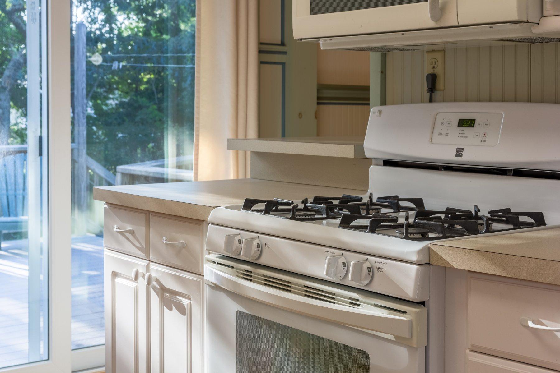 2 Otis Kelly Road Dennis Port, MA 02639 - Photo 13 of 23 a kitchen with a stove and a white cabinet
