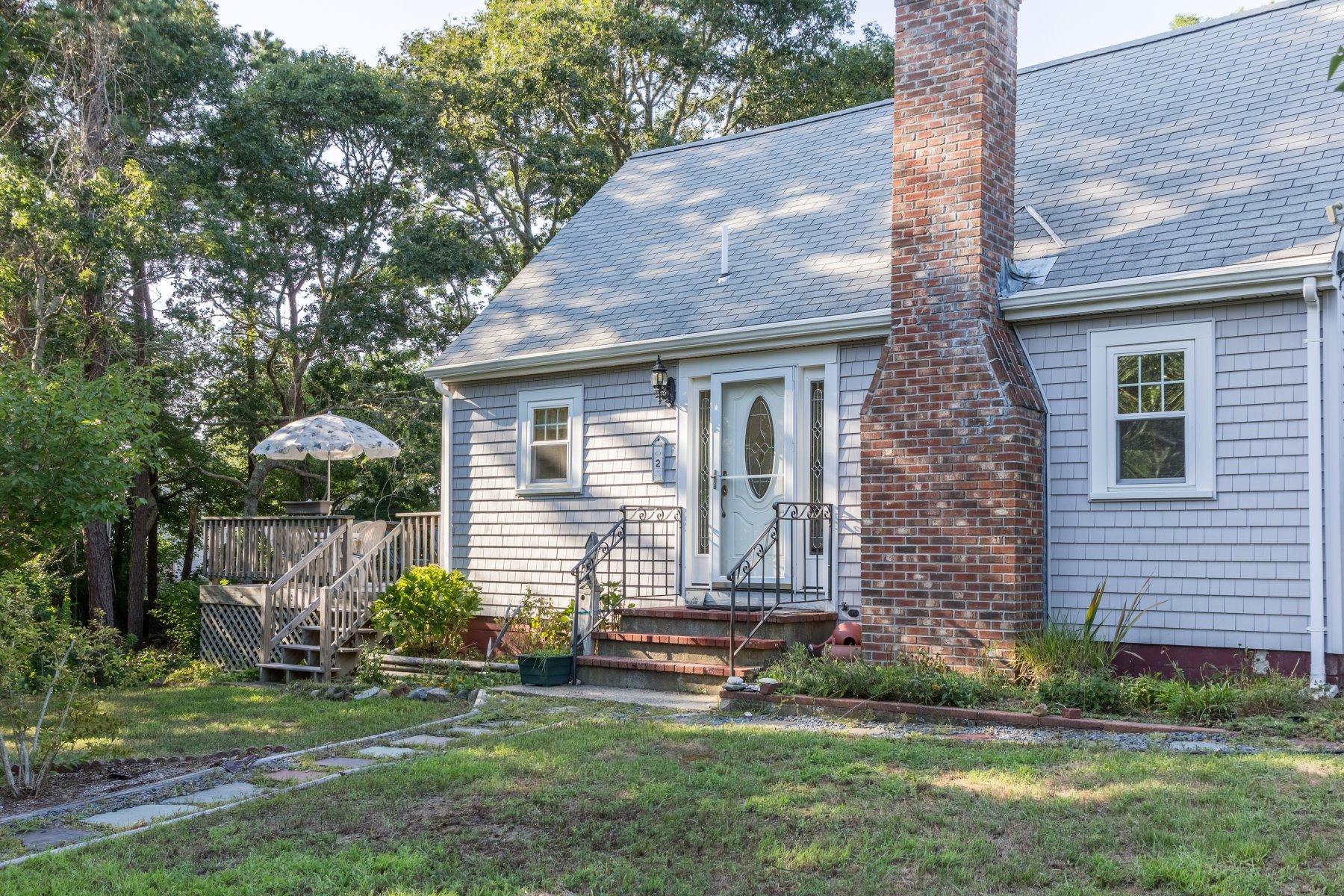 2 Otis Kelly Road Dennis Port, MA 02639 - Photo 2 of 23 a front view of a house with a garden and plants