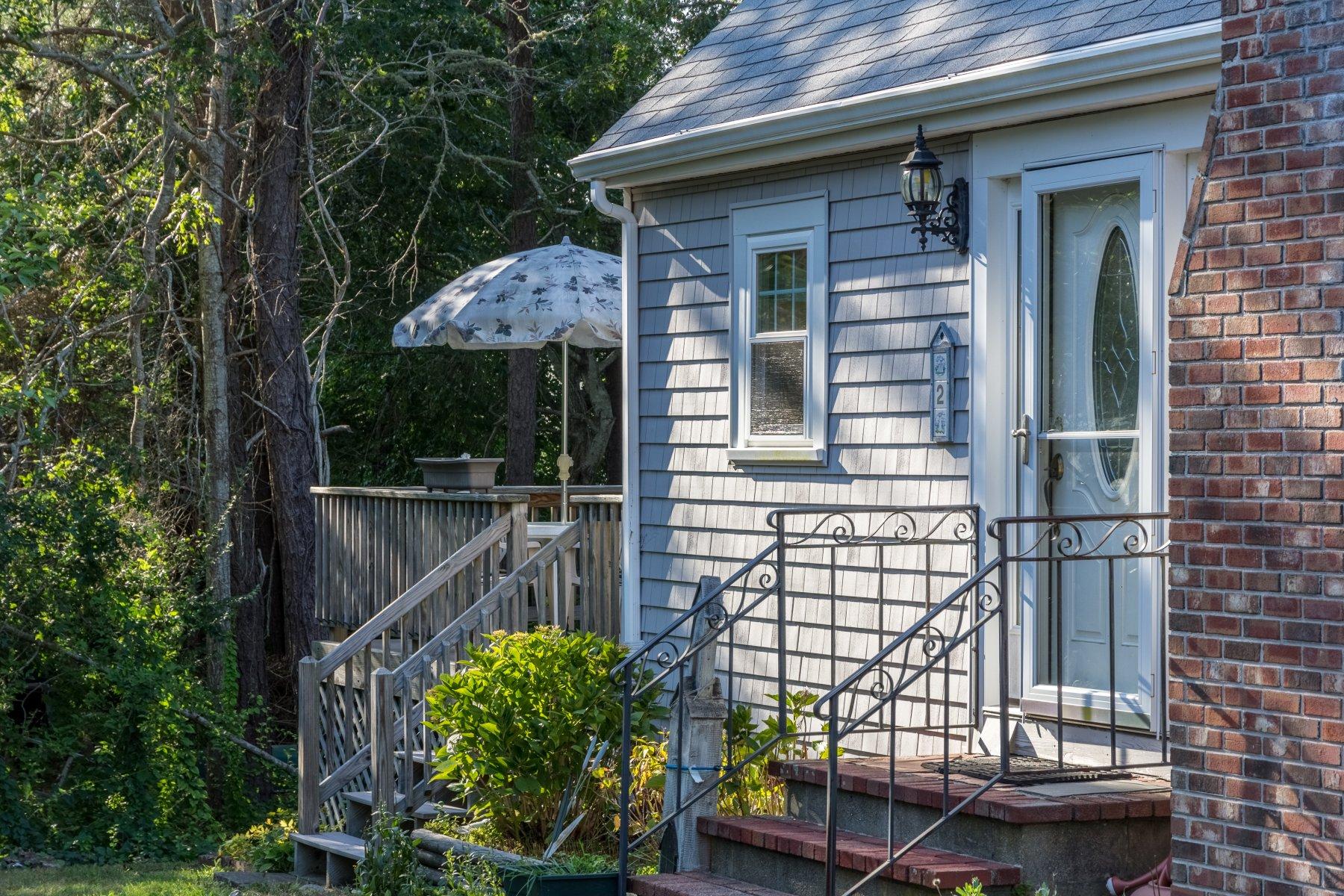 2 Otis Kelly Road Dennis Port, MA 02639 - Photo 3 of 23 a front view of a house with a garden