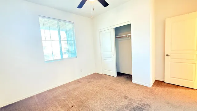 an empty room with windows and closet