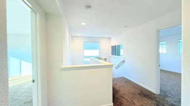 a view of hallway with wooden floor